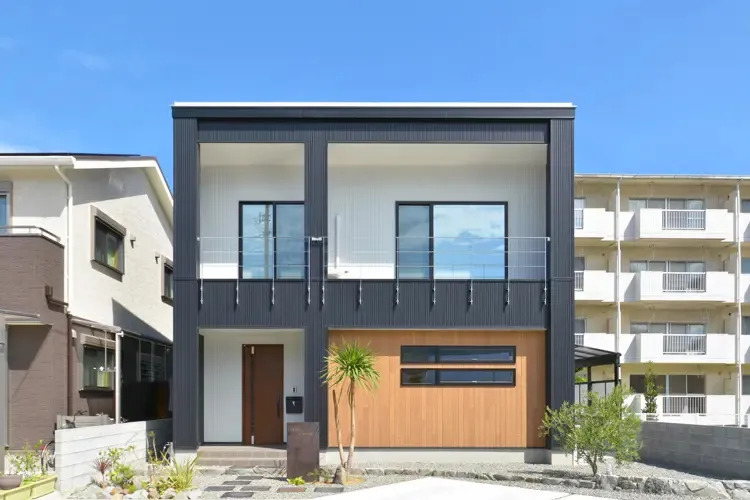 スクエア型のシンプルな形状と、ブラック・ホワイト・木目の組み合わせがおしゃれな住宅外観