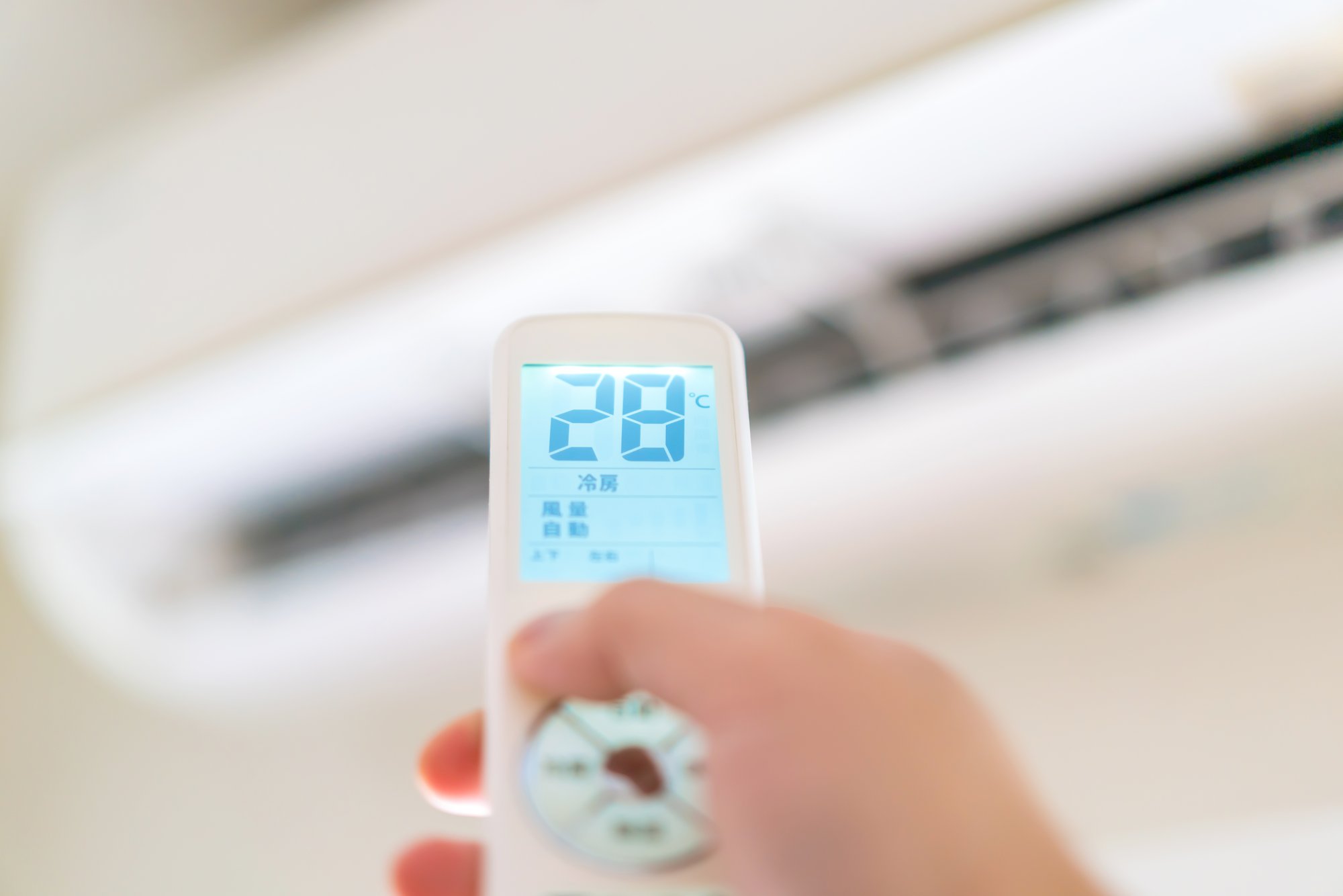 エアコンの冷房をつけるリモコンの手元